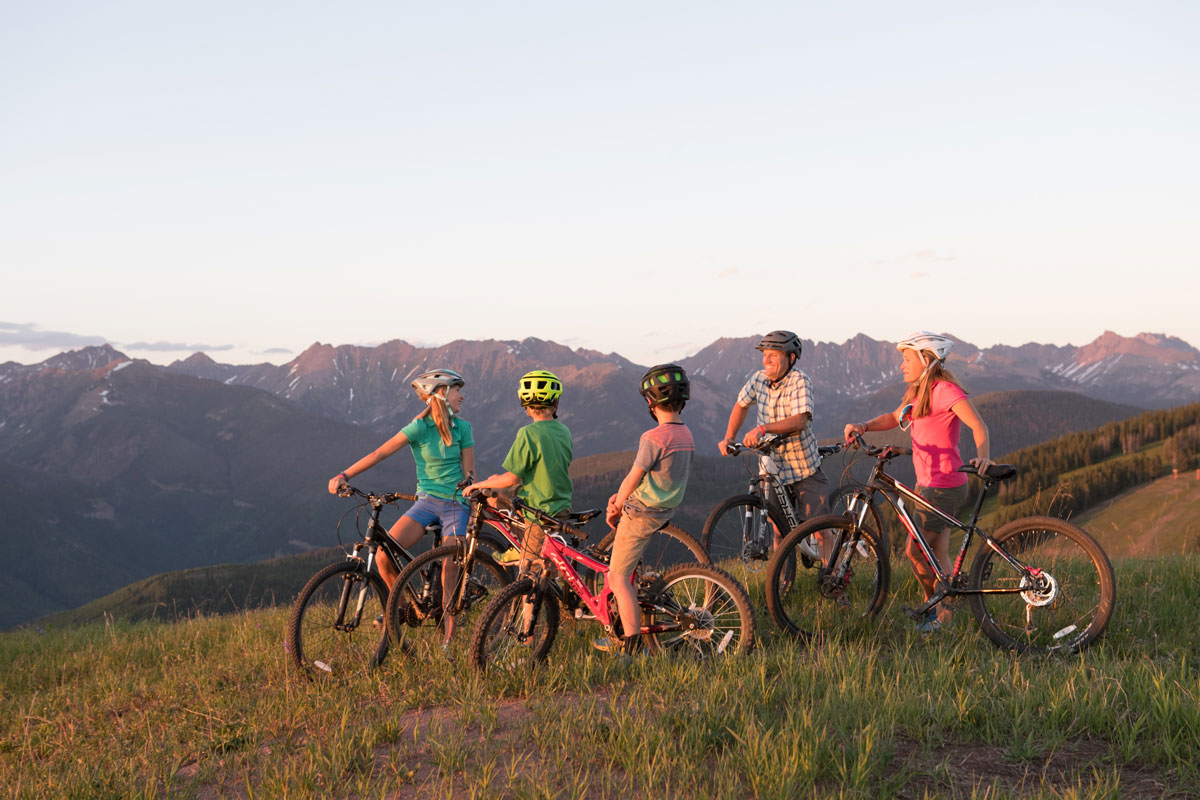 family mountain biking during warm weather at Vail Colorado