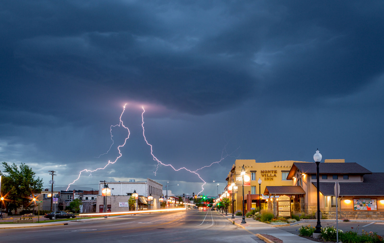 Two bolts of lighting strike out of a dark, stormy cloud over downtown Monte Vista. 