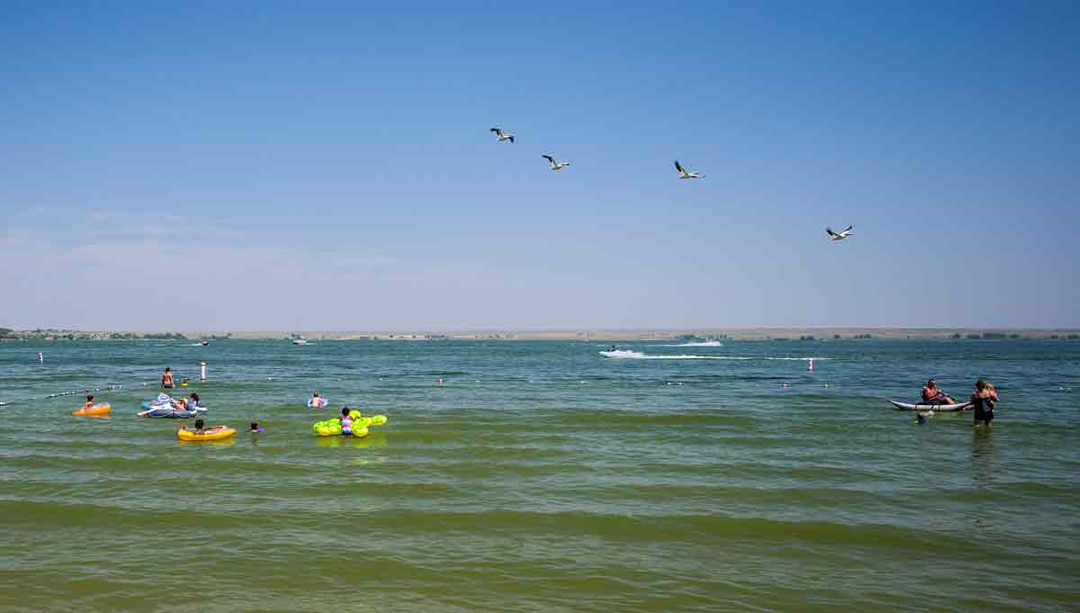 People kayaking and splashing around in the water at Jackson Lake