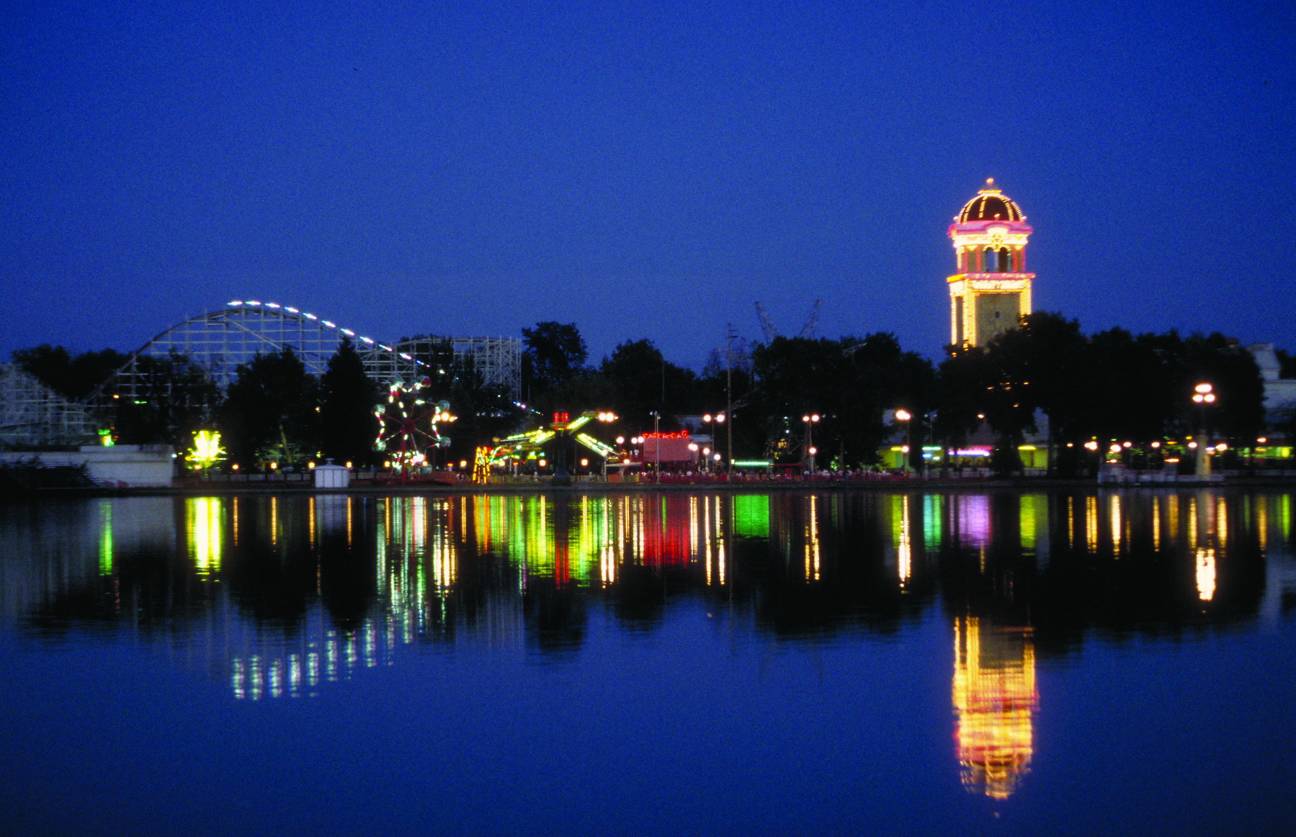 lakeside amusement park across lake at night photo